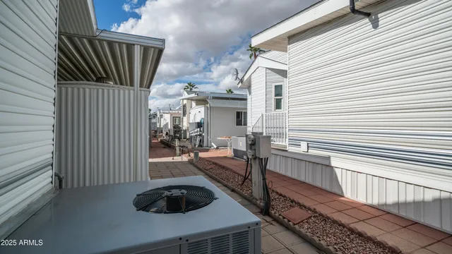 a view of a porch with wooden floor and floor to ceiling window