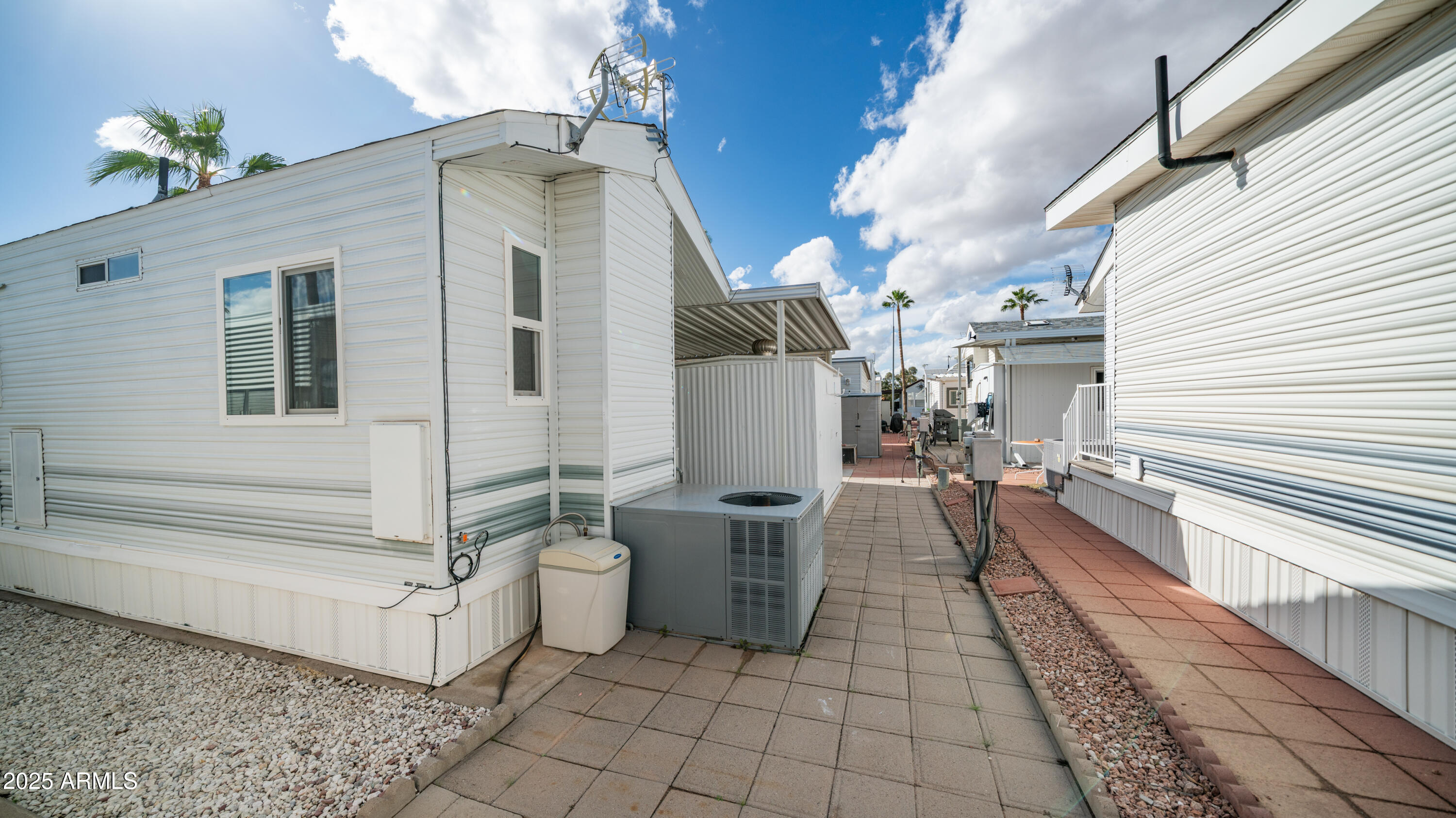 656 Gypsum Drive, Unit 656 Apache Junction, AZ 85119 - Photo 21 of 52 a view of a patio with couches and potted plants