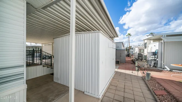 a view of a house with backyard and sitting area