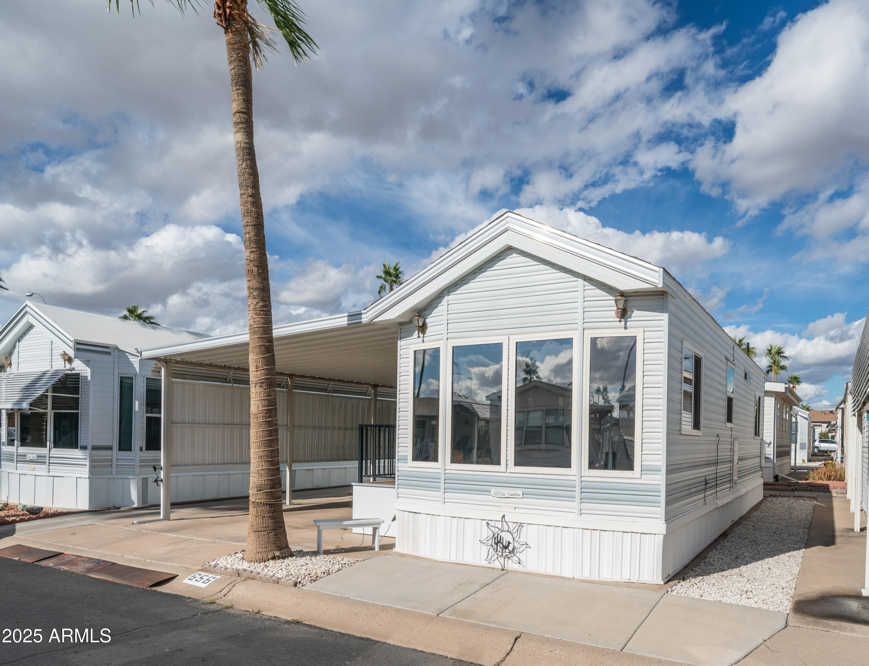 656 Gypsum Drive, Unit 656 Apache Junction, AZ 85119 - Photo 4 of 52 a view of a white house with a large windows