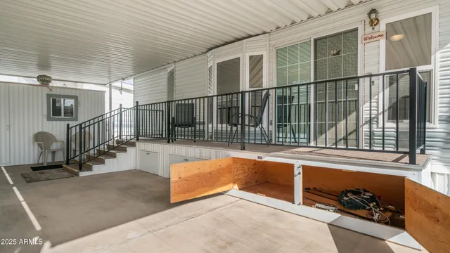 a view of a porch with wooden floor and fence