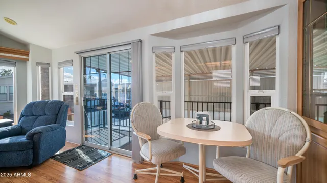 a dining room with furniture and wooden floor
