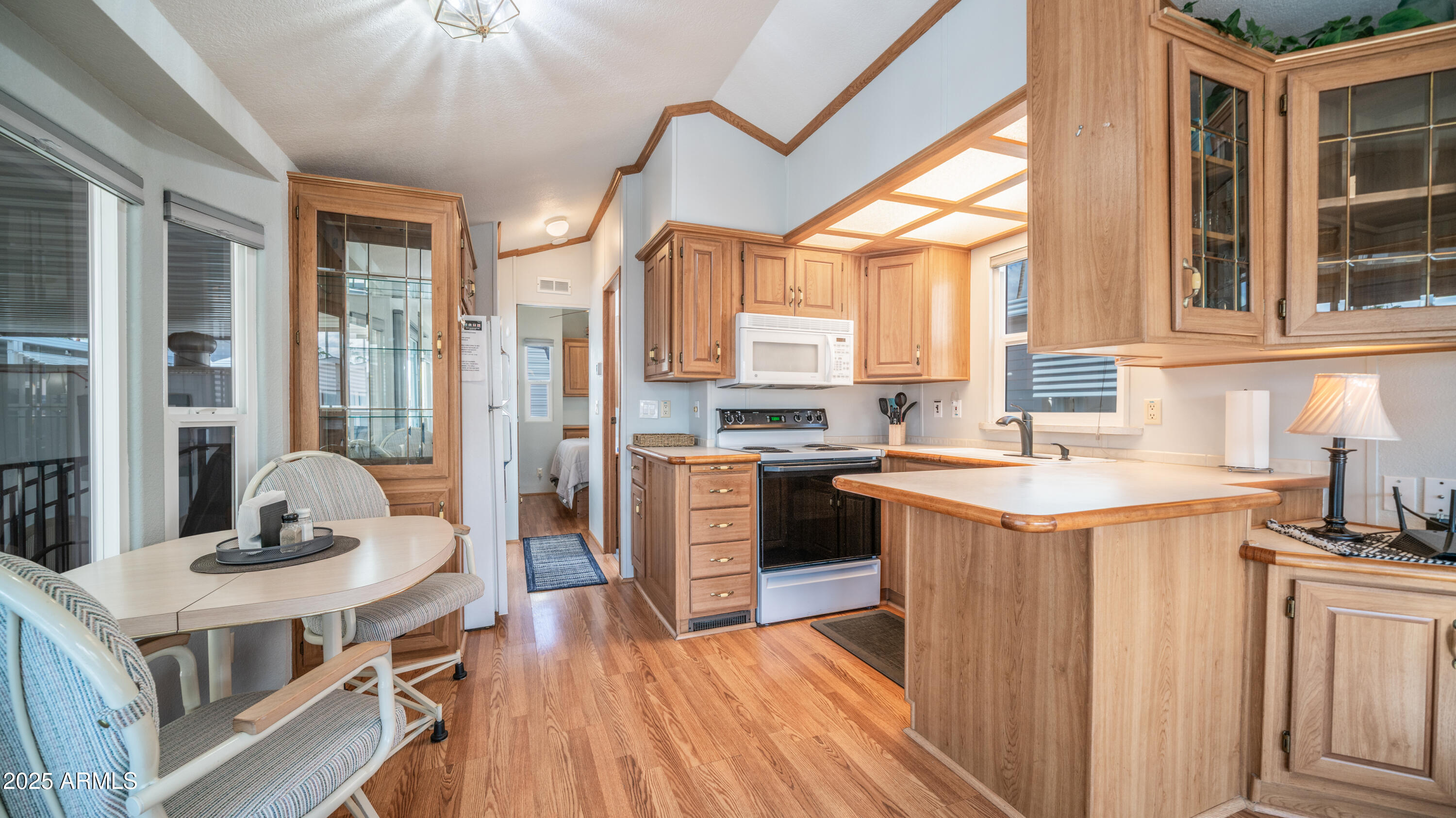 656 Gypsum Drive, Unit 656 Apache Junction, AZ 85119 - Photo 9 of 52 a kitchen with a stove a sink and a refrigerator