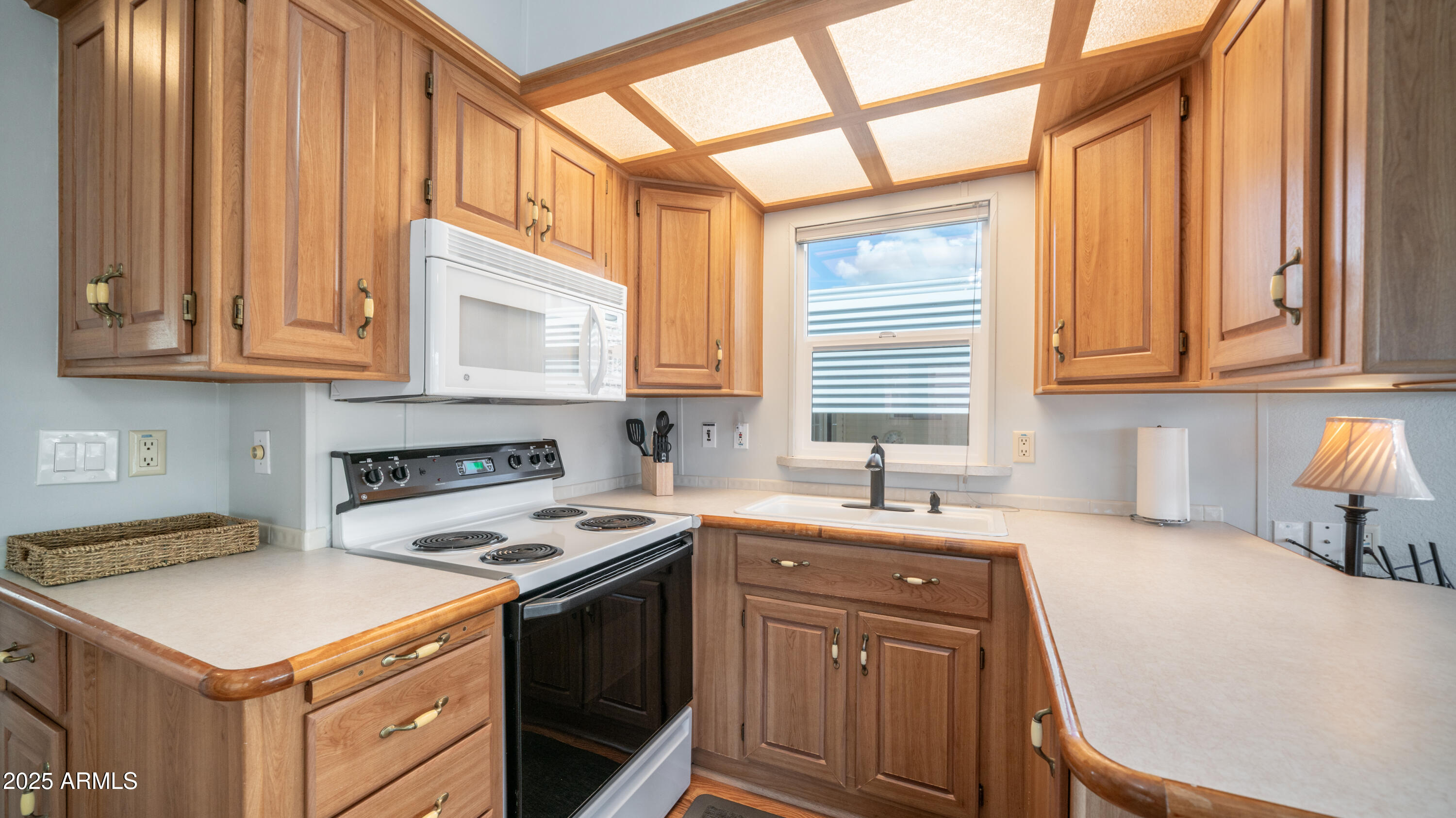 656 Gypsum Drive, Unit 656 Apache Junction, AZ 85119 - Photo 10 of 52 a kitchen with a sink stove and cabinets