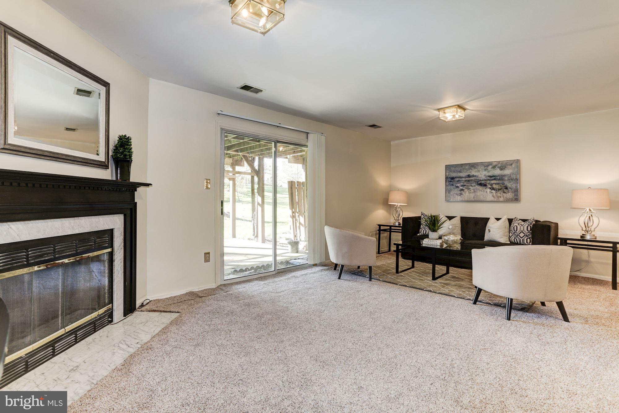 6819 Mayfair Road Laurel, MD 20707 - Photo 7 of 40 1st floor family room w/ fireplace & exit to patio