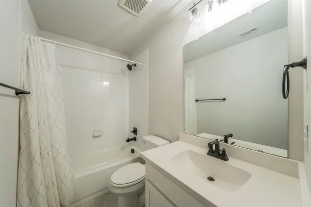 a bathroom with a sink toilet tub and shower