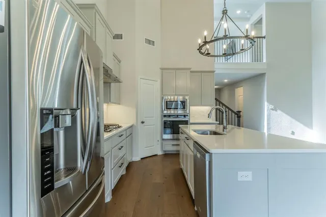 a kitchen with cabinets and wooden floor