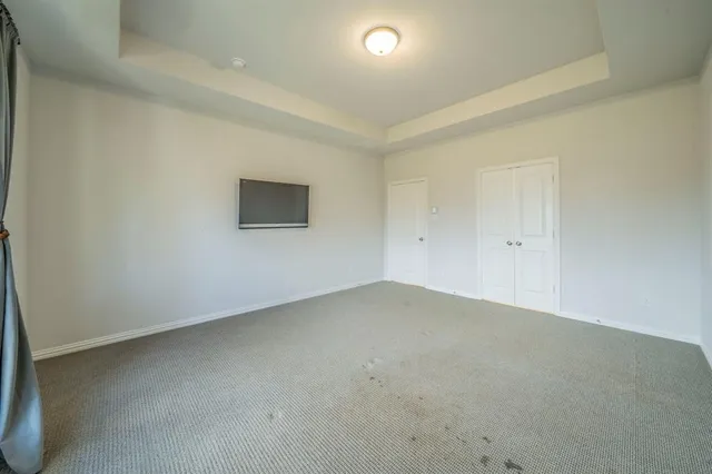 an empty room with a empty space and windows