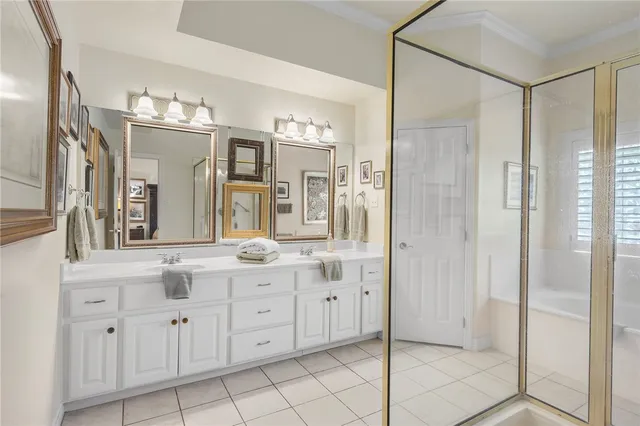a spacious bathroom with a granite countertop sink mirror and shower