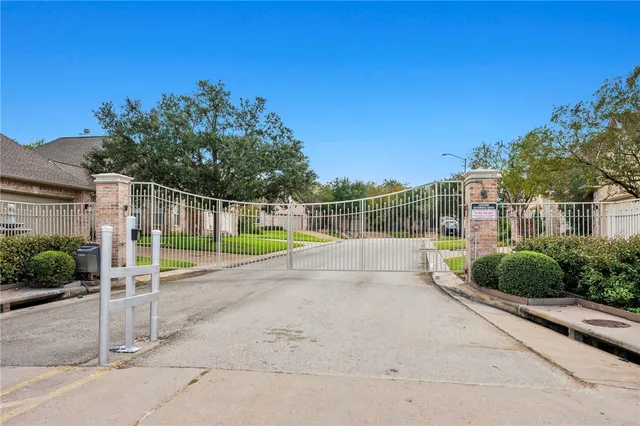 a view of a park with iron fence