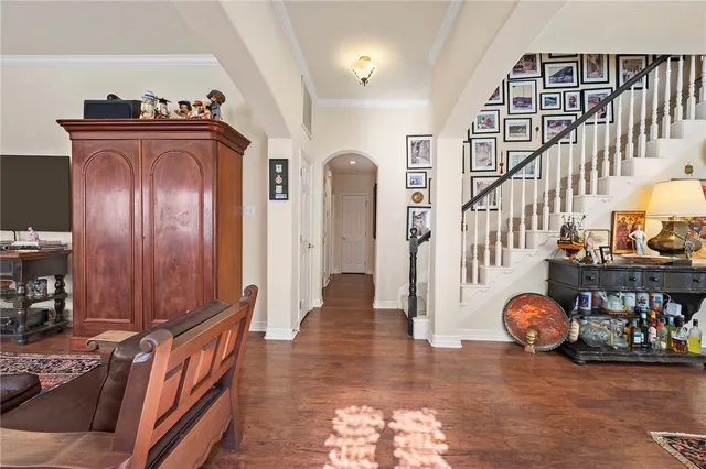 a view of a hallway with entryway wooden floor and front door