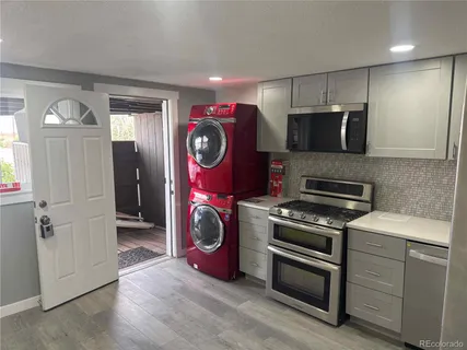 a kitchen with a stove a refrigerator and a microwave
