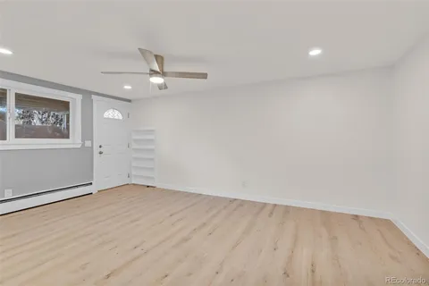 wooden floor in an empty room with a window