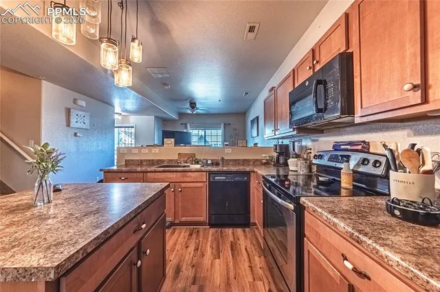 a kitchen with stainless steel appliances granite countertop a stove and a sink