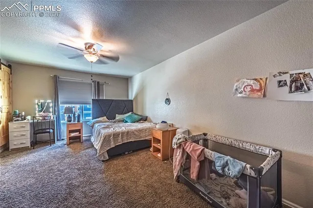a bedroom with furniture and a chandelier