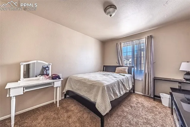 a bedroom with a bed and a table in it