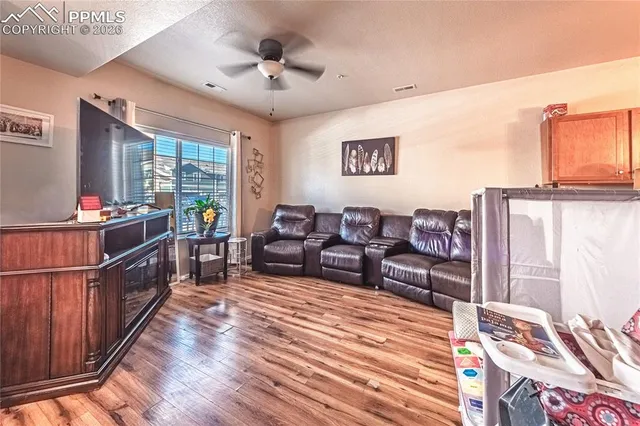 a living room with furniture windows and wooden floor