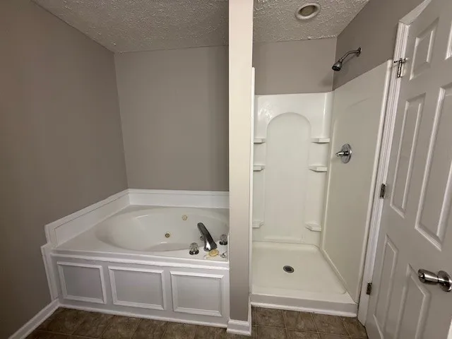 a white bath tub sitting next to a shower