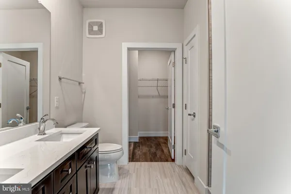 a bathroom with a sink a toilet a shower and a mirror