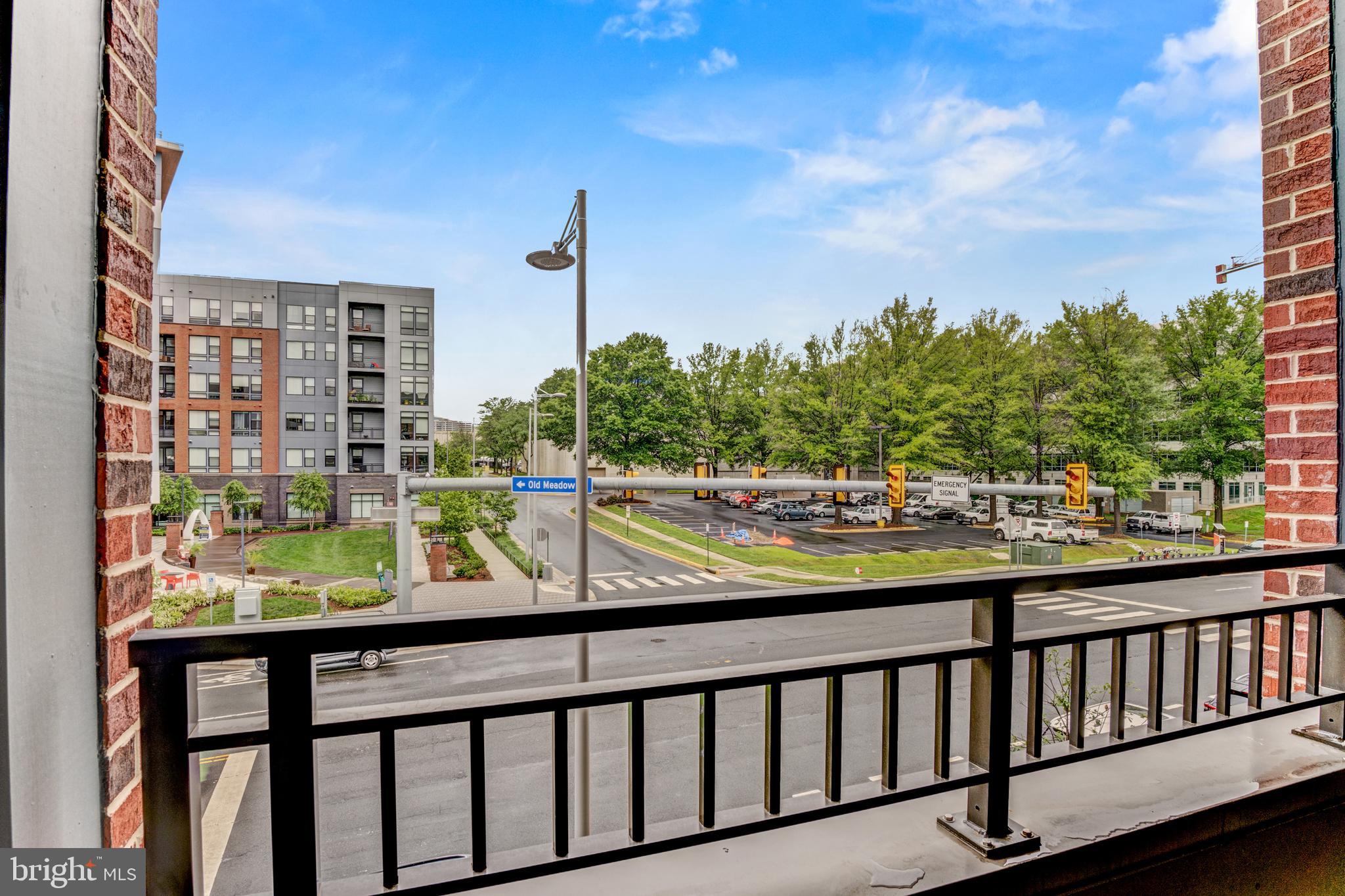 1761 Old Meadow Road, Unit 209 McLean, VA 22102 - Photo 15 of 58 a view of swimming pool from a balcony