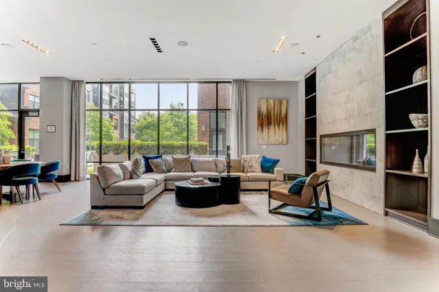 a living room with furniture large window and flat screen tv