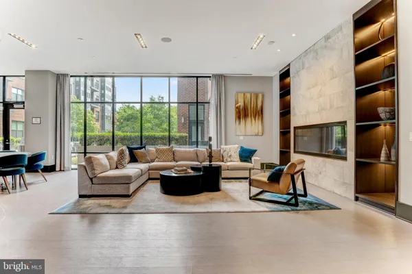a living room with furniture and a kitchen