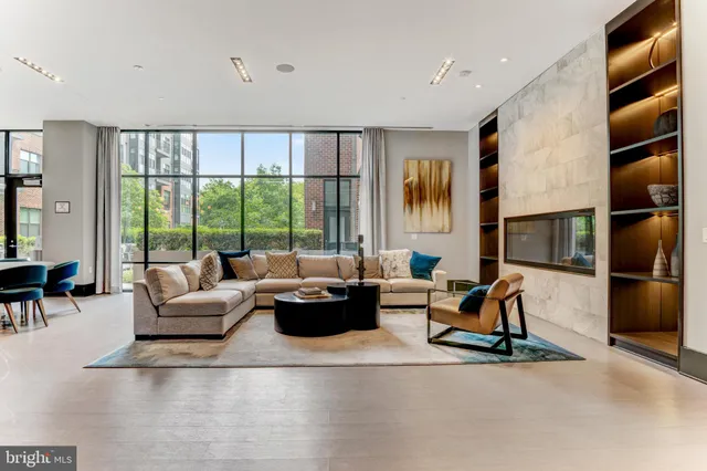 a living room with furniture and a kitchen