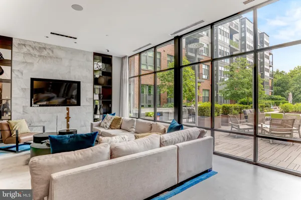 a living room with furniture and large windows