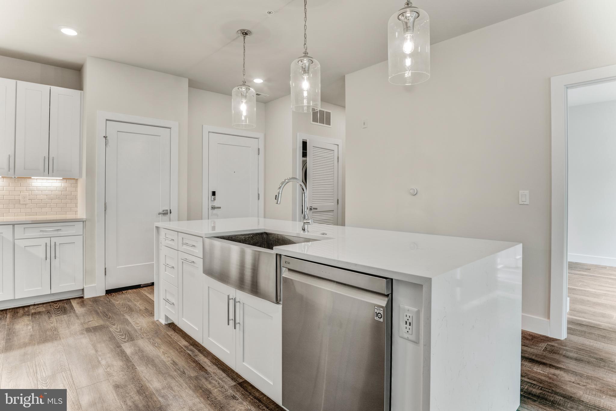 1761 Old Meadow Road, Unit 209 McLean, VA 22102 - Photo 3 of 58 a kitchen that has a lot of cabinets in it