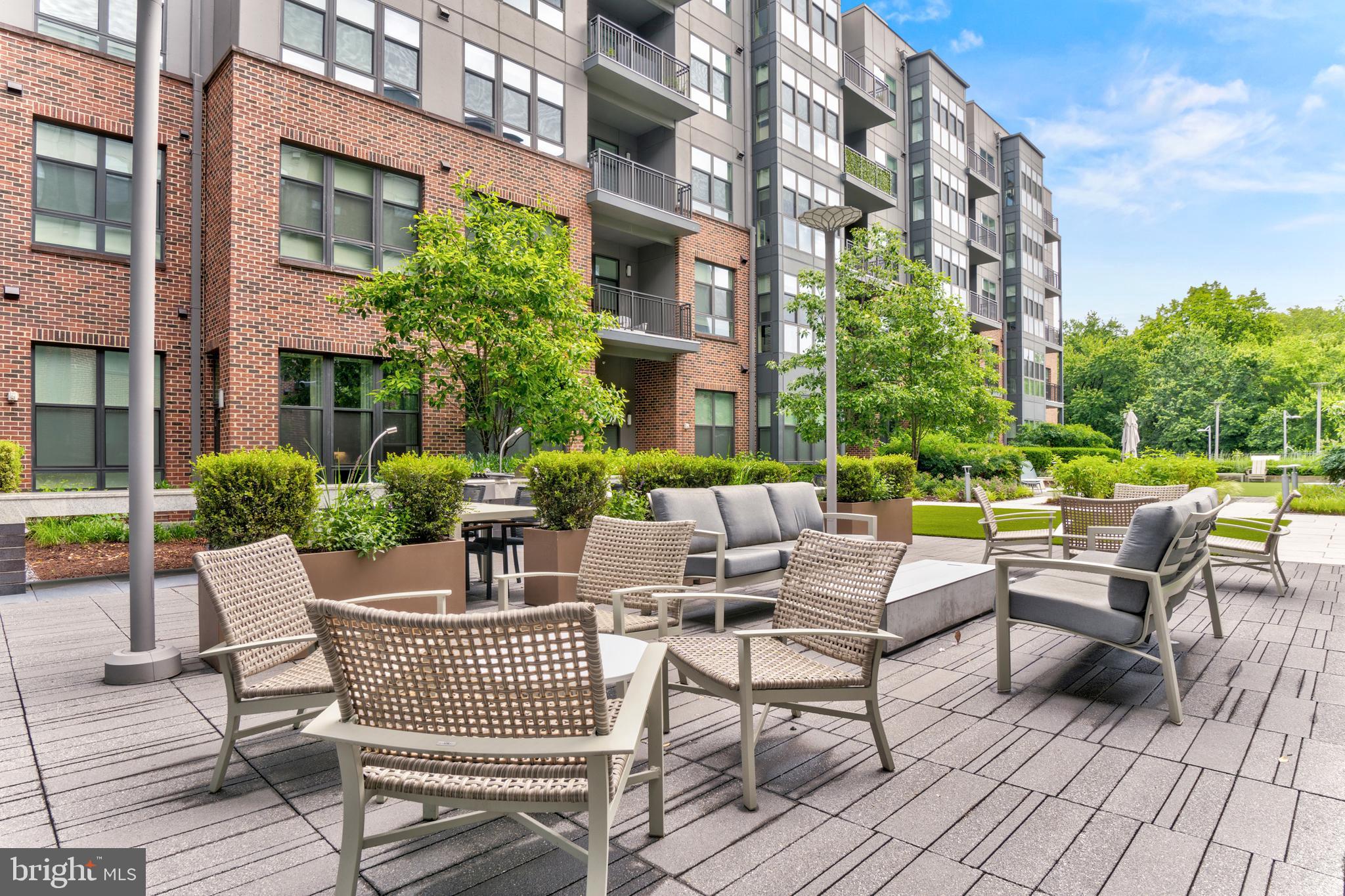 1761 Old Meadow Road, Unit 209 McLean, VA 22102 - Photo 32 of 58 a view of a patio with couches table and chairs and potted plants