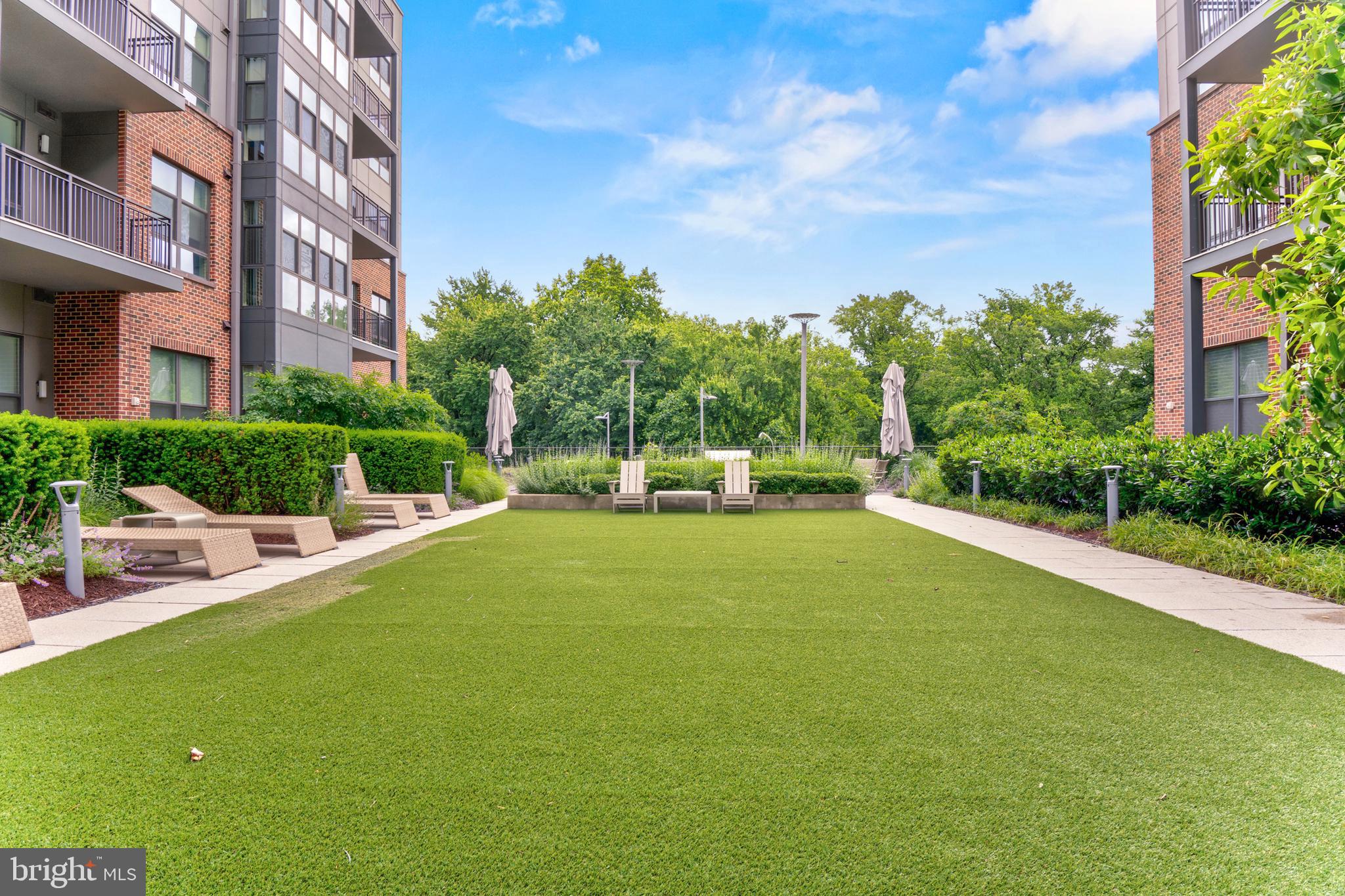 1761 Old Meadow Road, Unit 209 McLean, VA 22102 - Photo 34 of 58 a view of a swimming pool and a yard