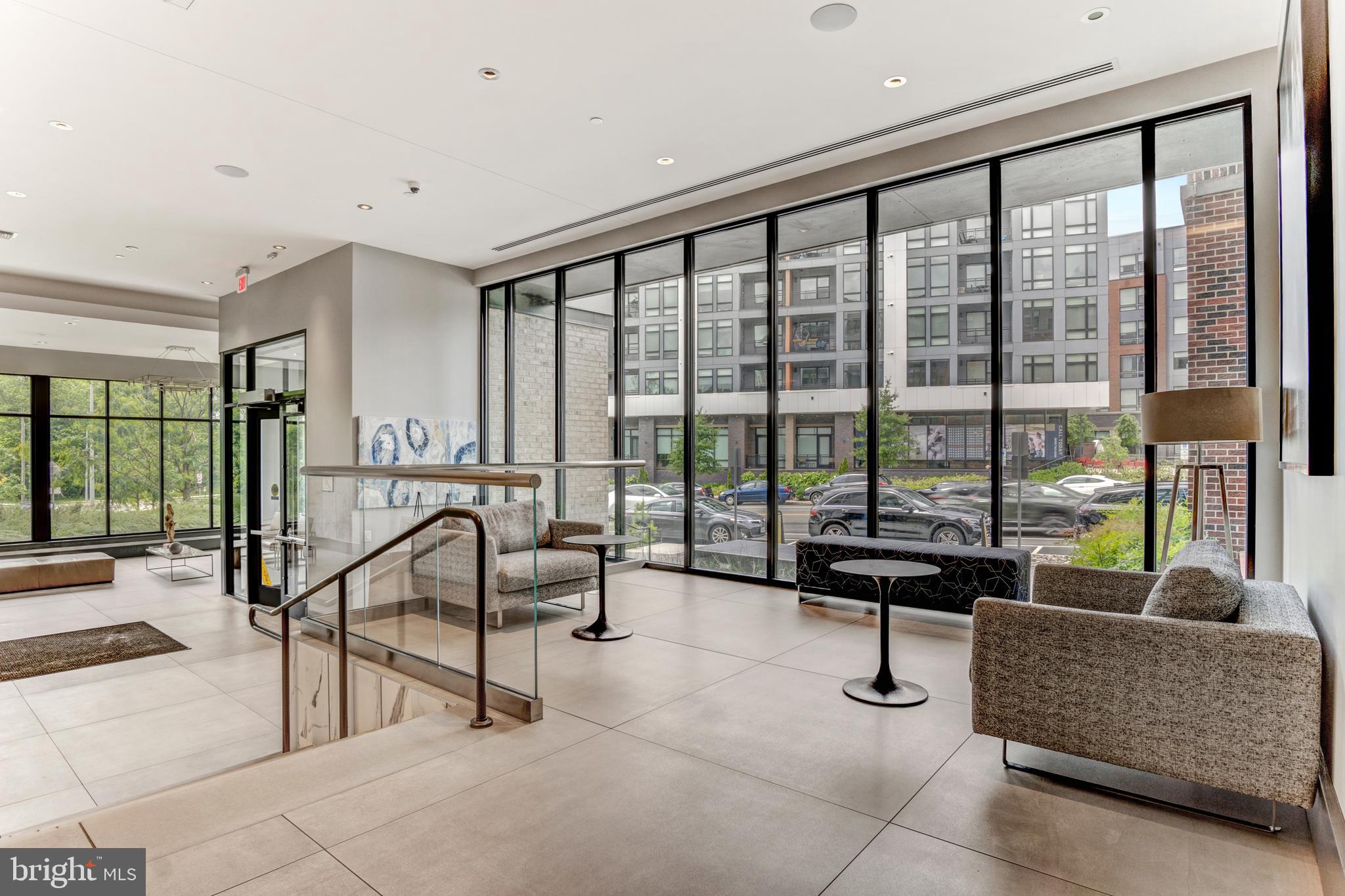 1761 Old Meadow Road, Unit 209 McLean, VA 22102 - Photo 42 of 58 a living room with furniture and a floor to ceiling window