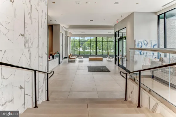 a front view of a building with a garden and pathway