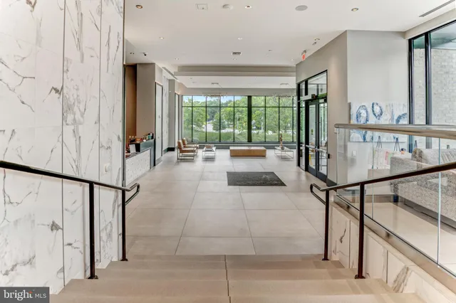 a front view of a building with a garden and pathway