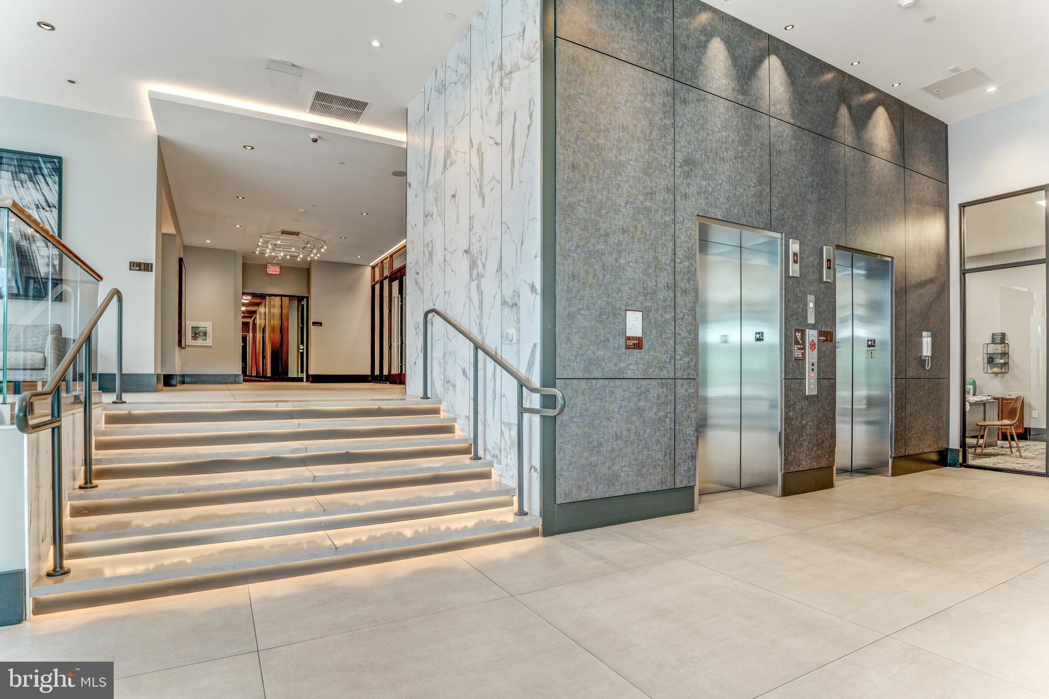 1761 Old Meadow Road, Unit 209 McLean, VA 22102 - Photo 46 of 58 a view of a hallway with wooden floor and staircase