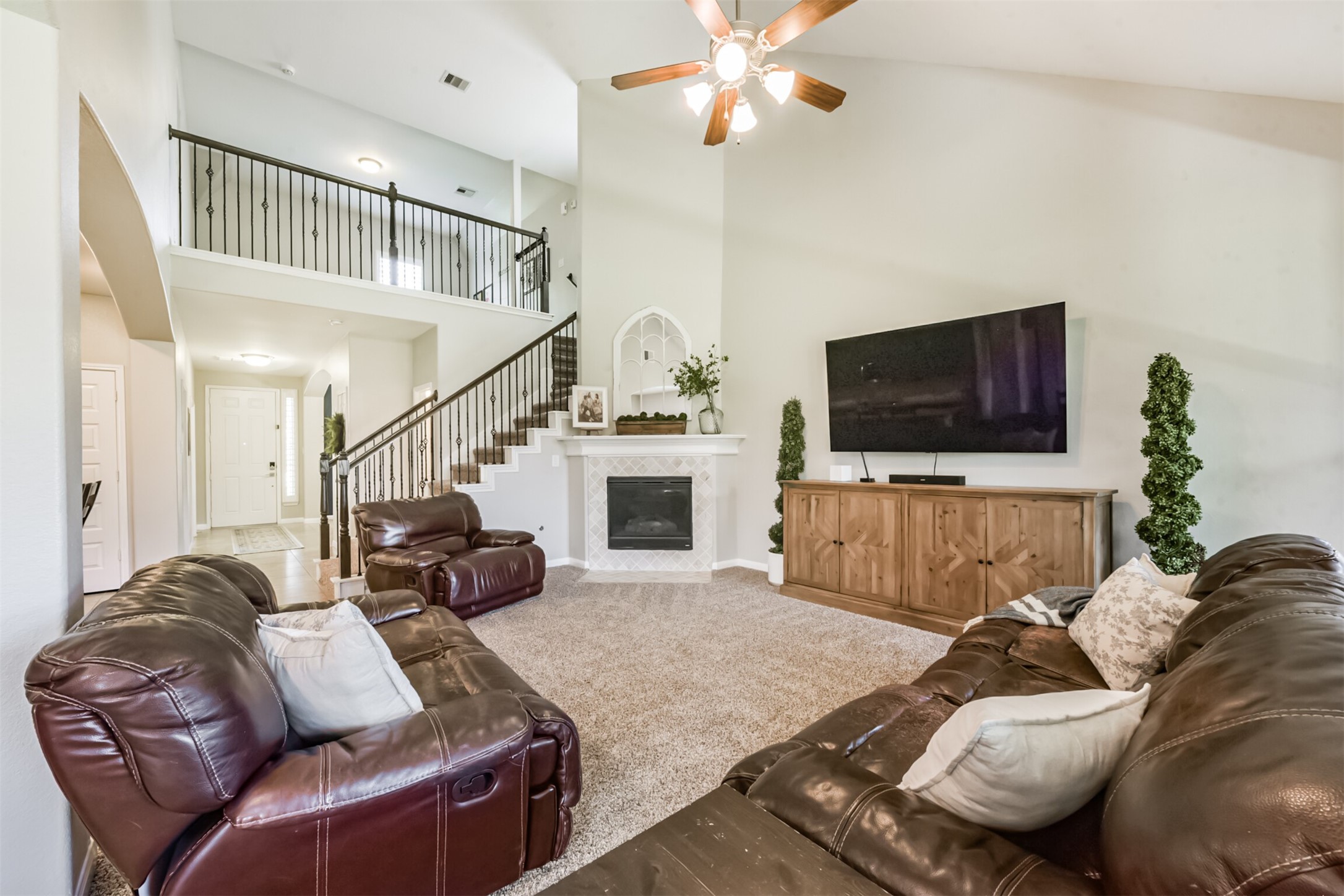 17120 Edge Branch Lane Houston, TX 77044 - Photo 20 of 50 a living room with furniture a flat screen tv and a fireplace
