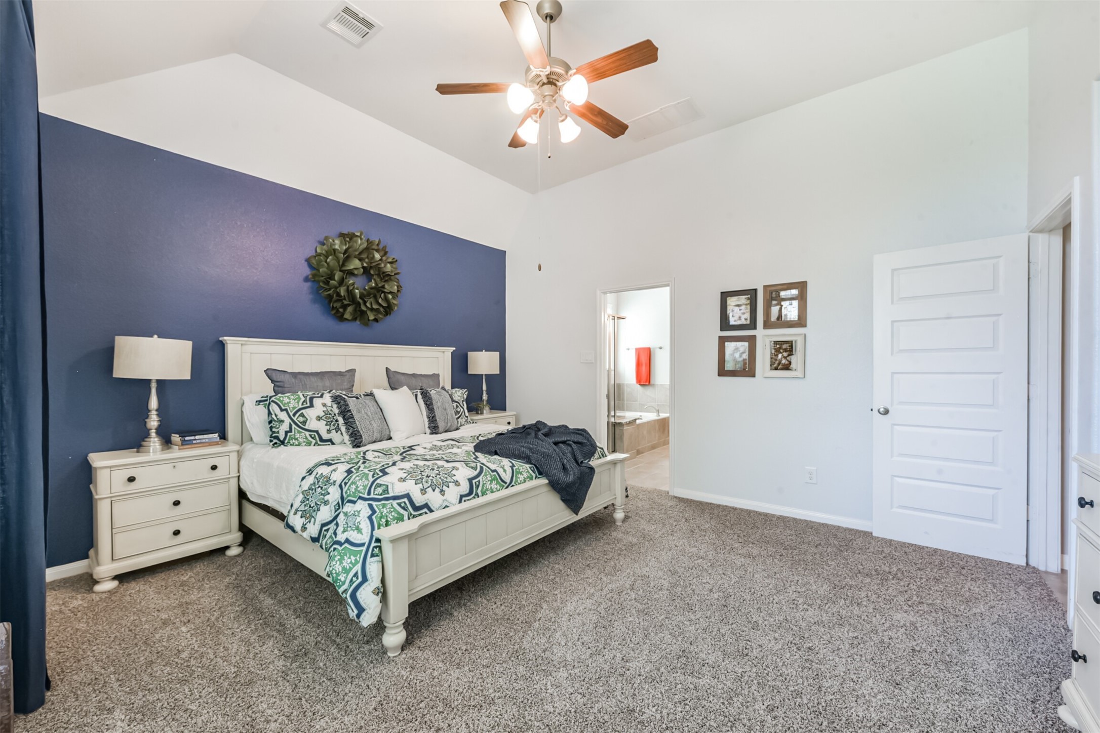 17120 Edge Branch Lane Houston, TX 77044 - Photo 26 of 50 a bedroom with a bed and a chandelier fan