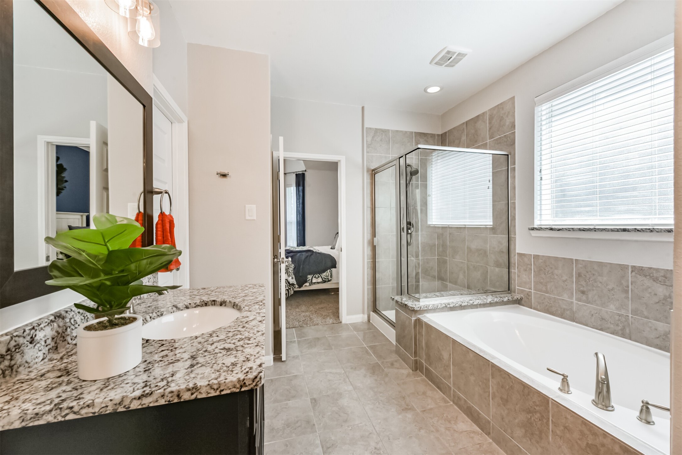 17120 Edge Branch Lane Houston, TX 77044 - Photo 29 of 50 a bathroom with sink granite tub shower and mirror