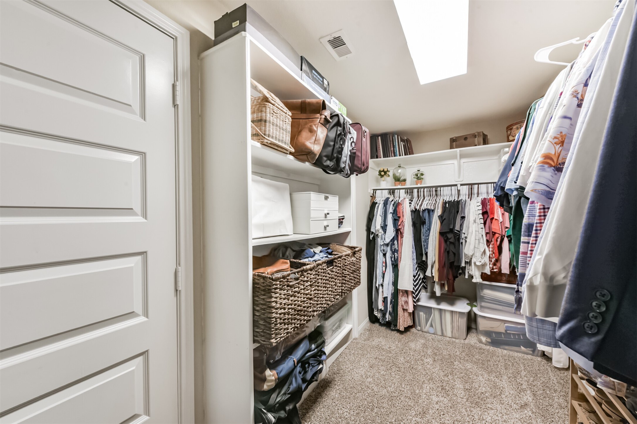 17120 Edge Branch Lane Houston, TX 77044 - Photo 30 of 50 a view of walk in closet with clothes and shoes