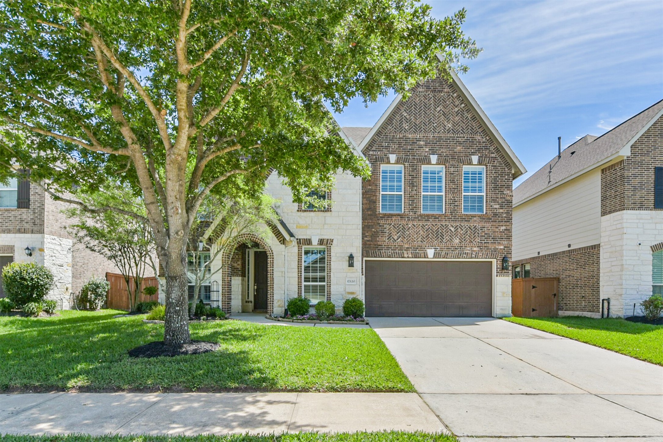 17120 Edge Branch Lane Houston, TX 77044 - Photo 3 of 50 a front view of a house with a garden and trees