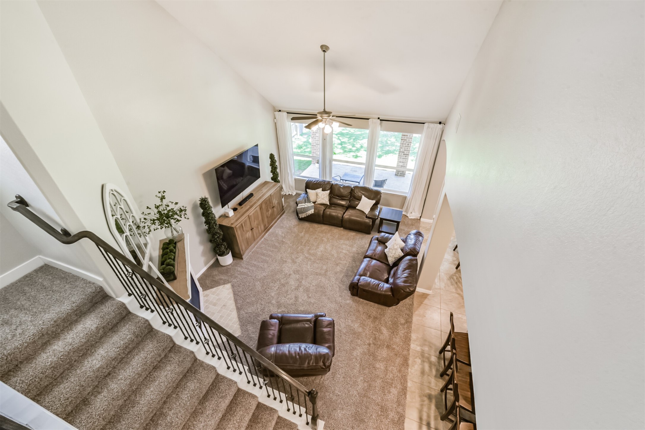 17120 Edge Branch Lane Houston, TX 77044 - Photo 31 of 50 a view of a living room with furniture and a flat screen tv