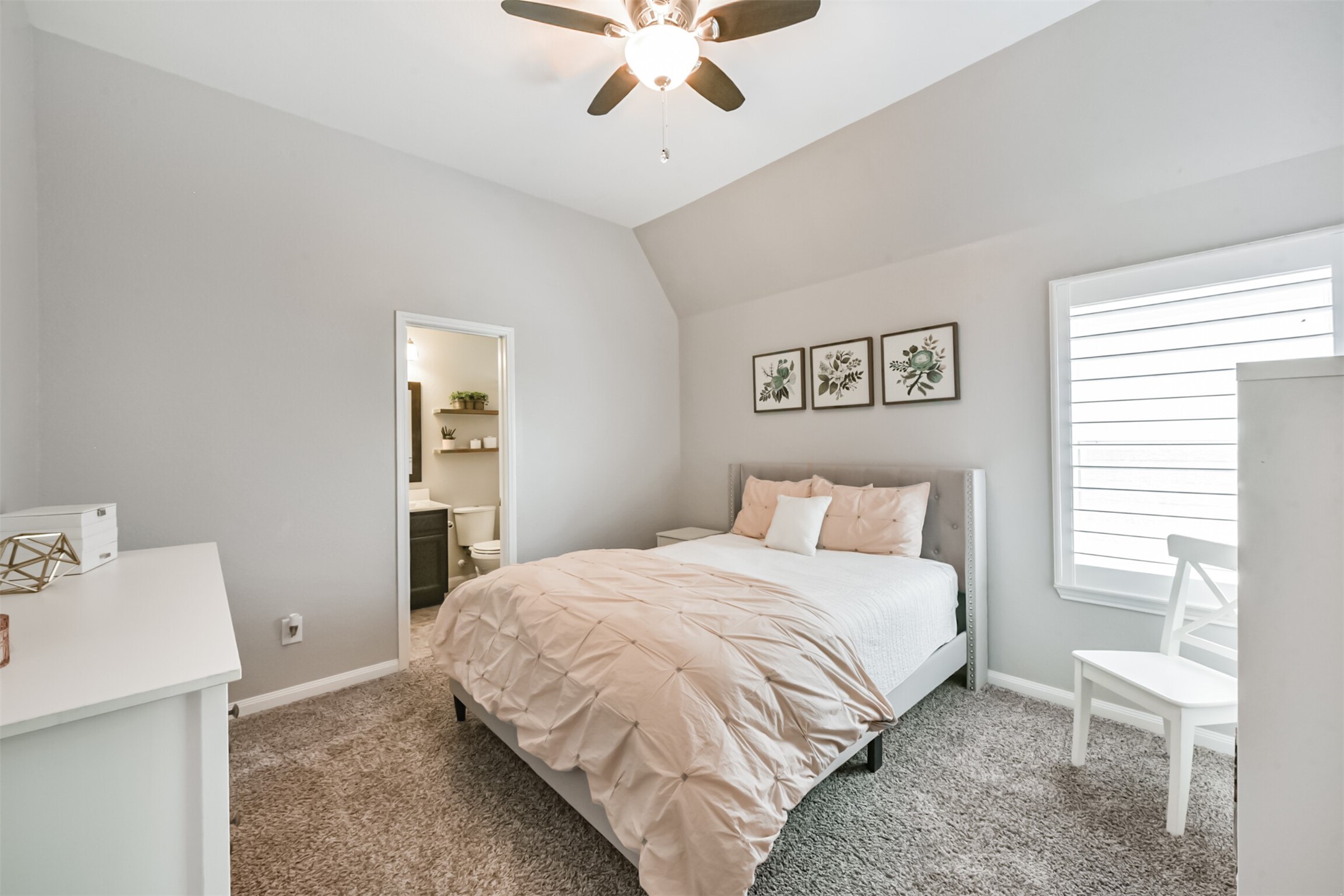 17120 Edge Branch Lane Houston, TX 77044 - Photo 35 of 50 a bedroom with a bed and a chandelier