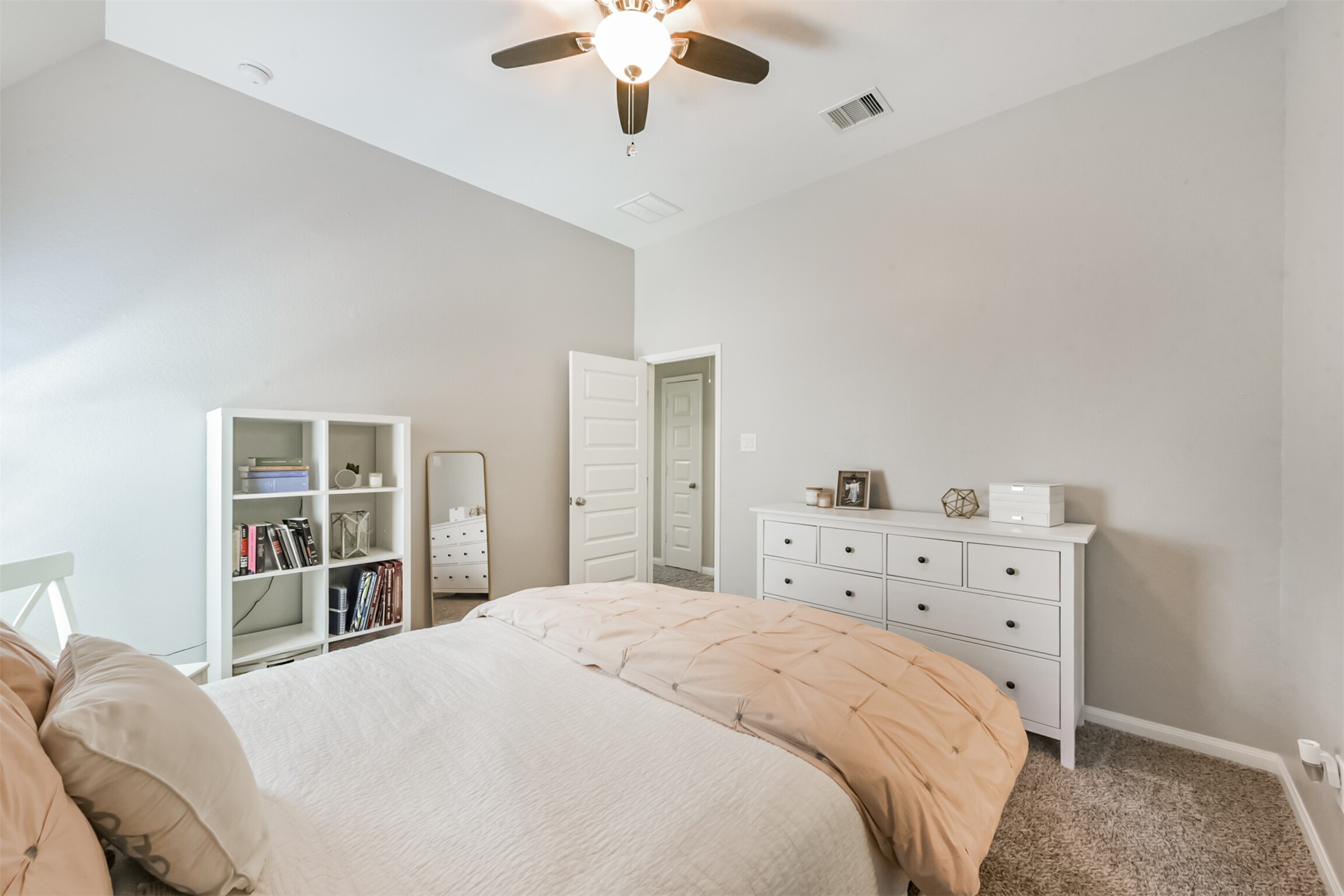 17120 Edge Branch Lane Houston, TX 77044 - Photo 36 of 50 a bedroom with a bed and a chandelier