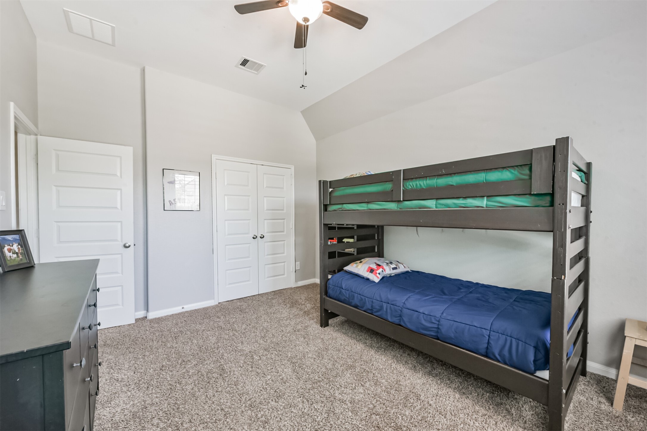 17120 Edge Branch Lane Houston, TX 77044 - Photo 39 of 50 a bedroom with a bed and a chandelier