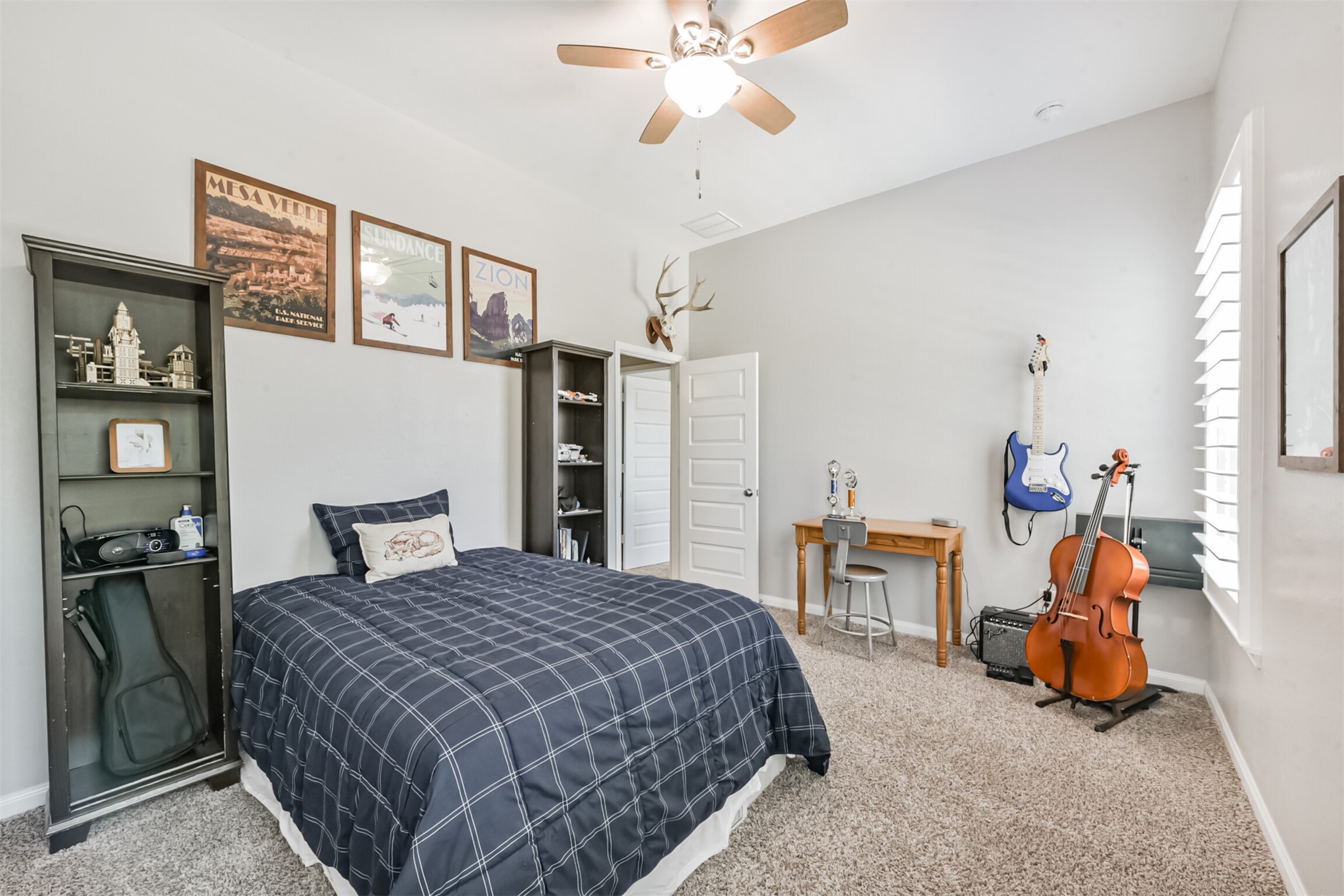 17120 Edge Branch Lane Houston, TX 77044 - Photo 42 of 50 a bedroom with a bed and a chandelier