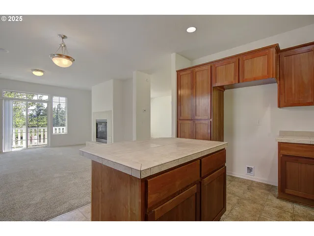 a kitchen that has a sink cabinets counter space and a window
