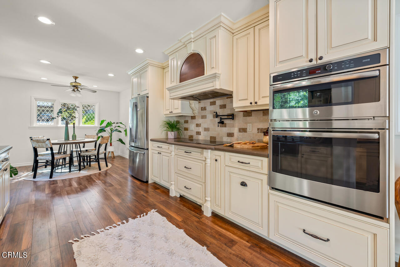 1425 Hillside Drive Glendale, CA 91208 - Photo 16 of 68 a kitchen with stainless steel appliances granite countertop a stove and white cabinets