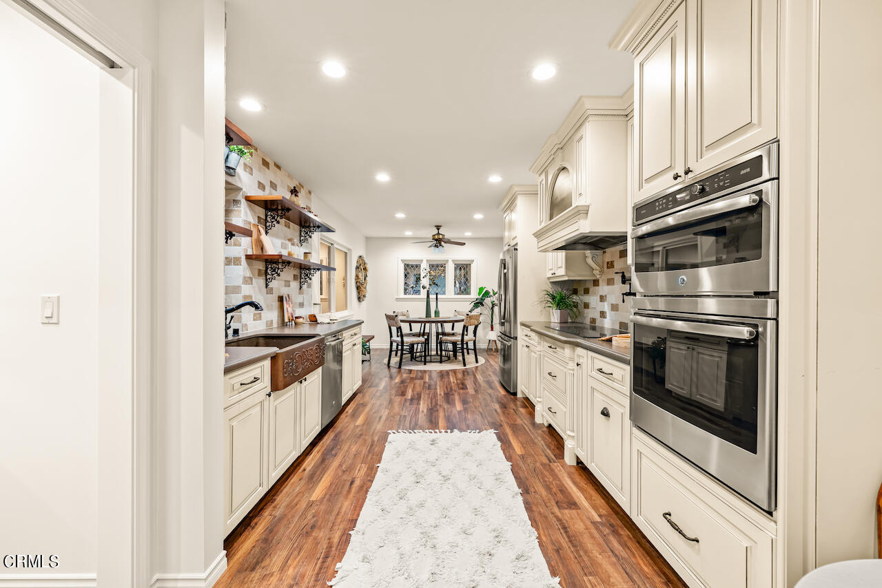 1425 Hillside Drive Glendale, CA 91208 - Photo 18 of 68 a kitchen with stainless steel appliances kitchen island granite countertop a refrigerator and a stove top oven