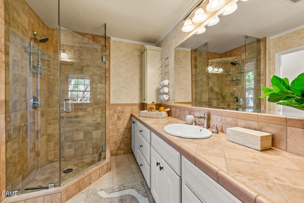 1425 Hillside Drive Glendale, CA 91208 - Photo 34 of 68 a bathroom with a granite countertop double vanity sink mirror double shower and a bathtub
