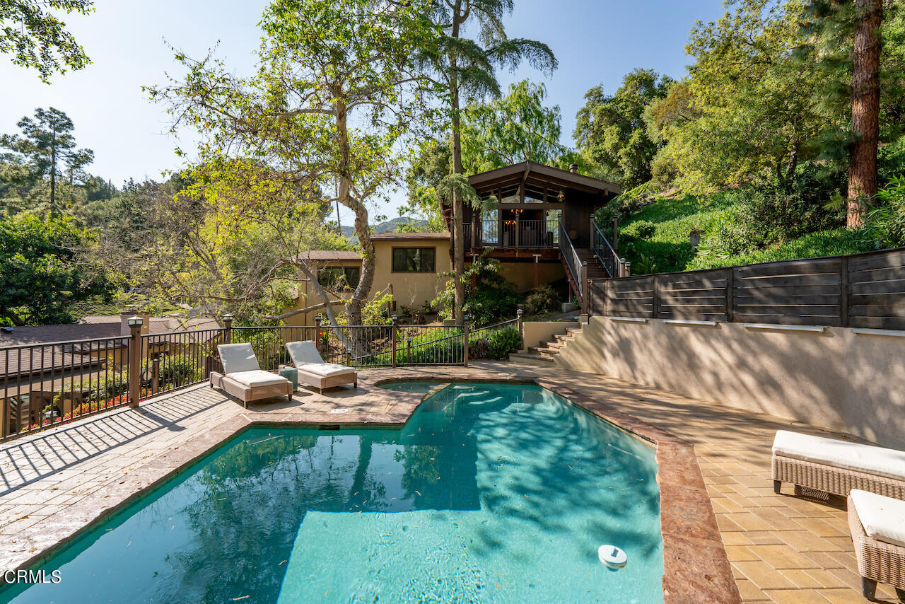 1425 Hillside Drive Glendale, CA 91208 - Photo 48 of 68 a backyard of a house with table and chairs potted plants and a large tree